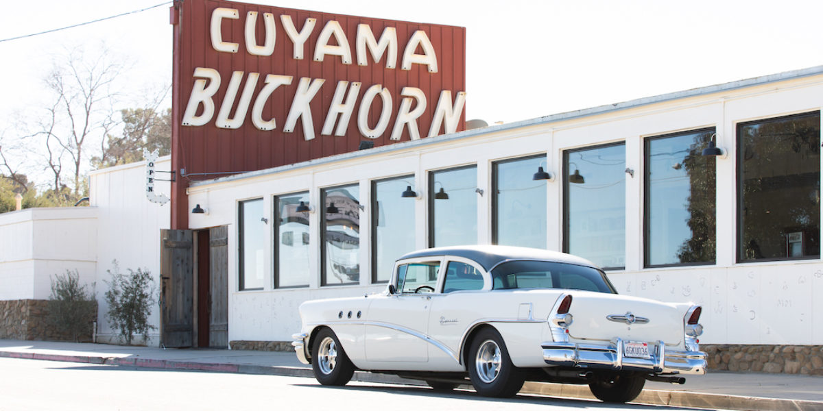 A classic car parks in front of Cuyama Buckhorn in Central California