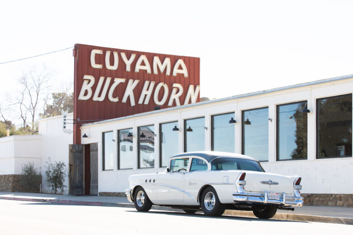 A classic car parks in front of Cuyama Buckhorn in Central California