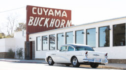 A classic car parks in front of Cuyama Buckhorn in Central California