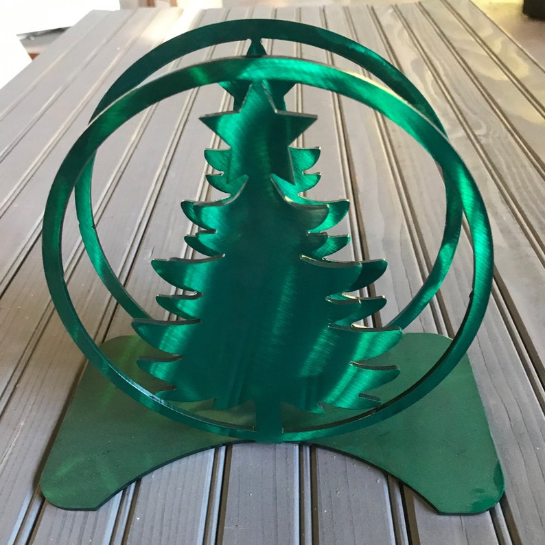 green holder with tree in ring