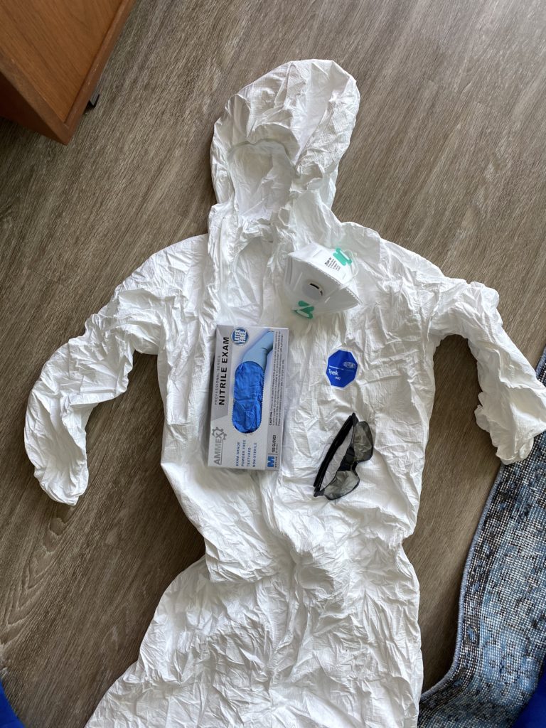 tyvek travel outfit with nitrile gloves and eye protection