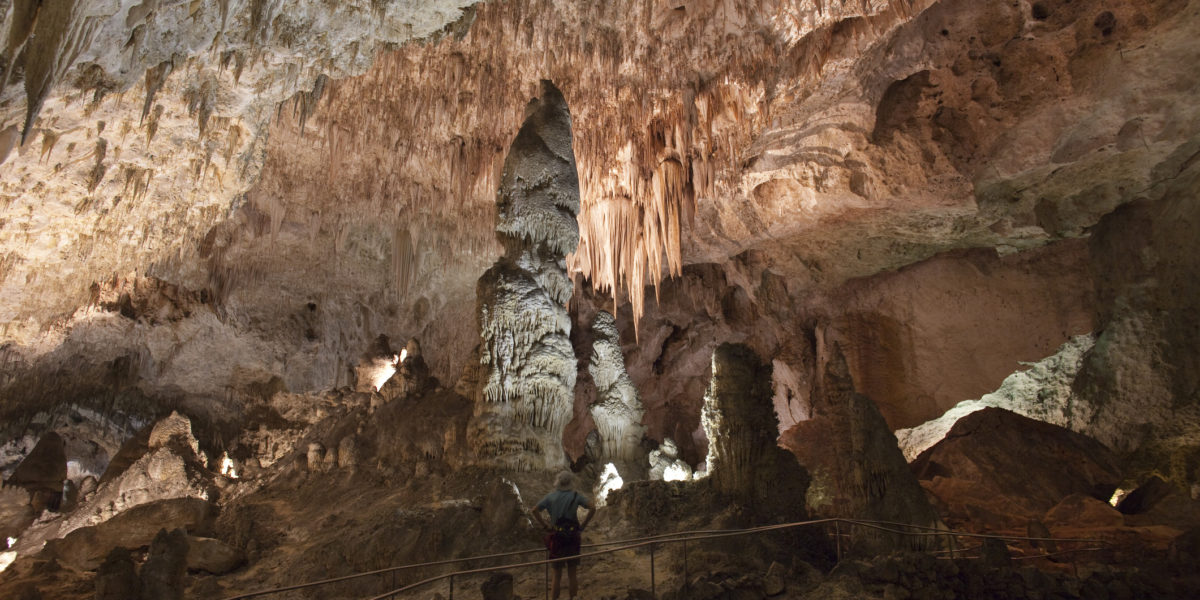 Visitor hikes Carlsbad Caverns Big Room Giant Chandelier New Mexico