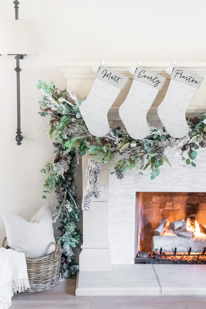 personalized white stockings hanging from mantle