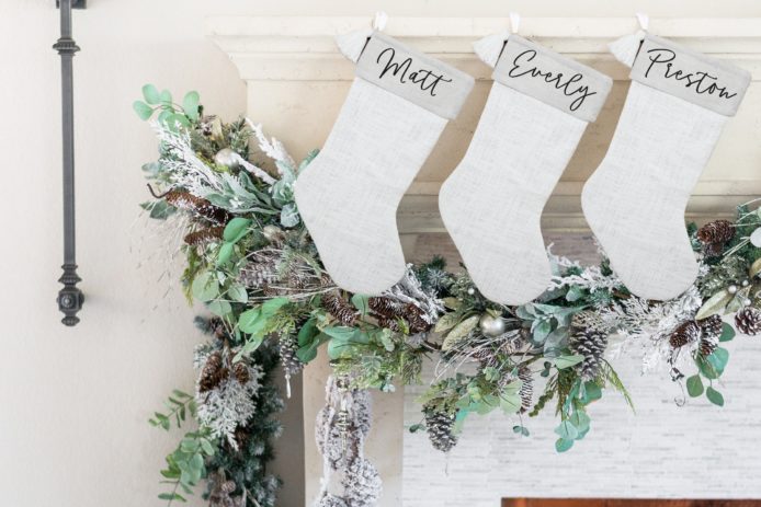 personalized white stockings hanging from mantle
