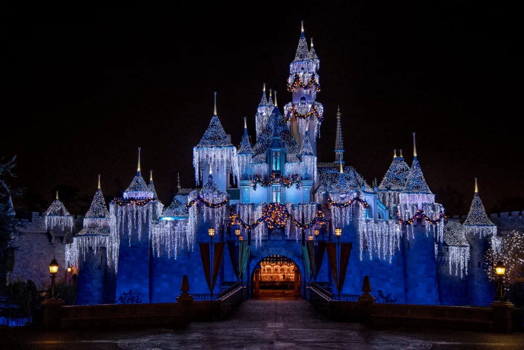 disney castle decorated with wreaths and lights
