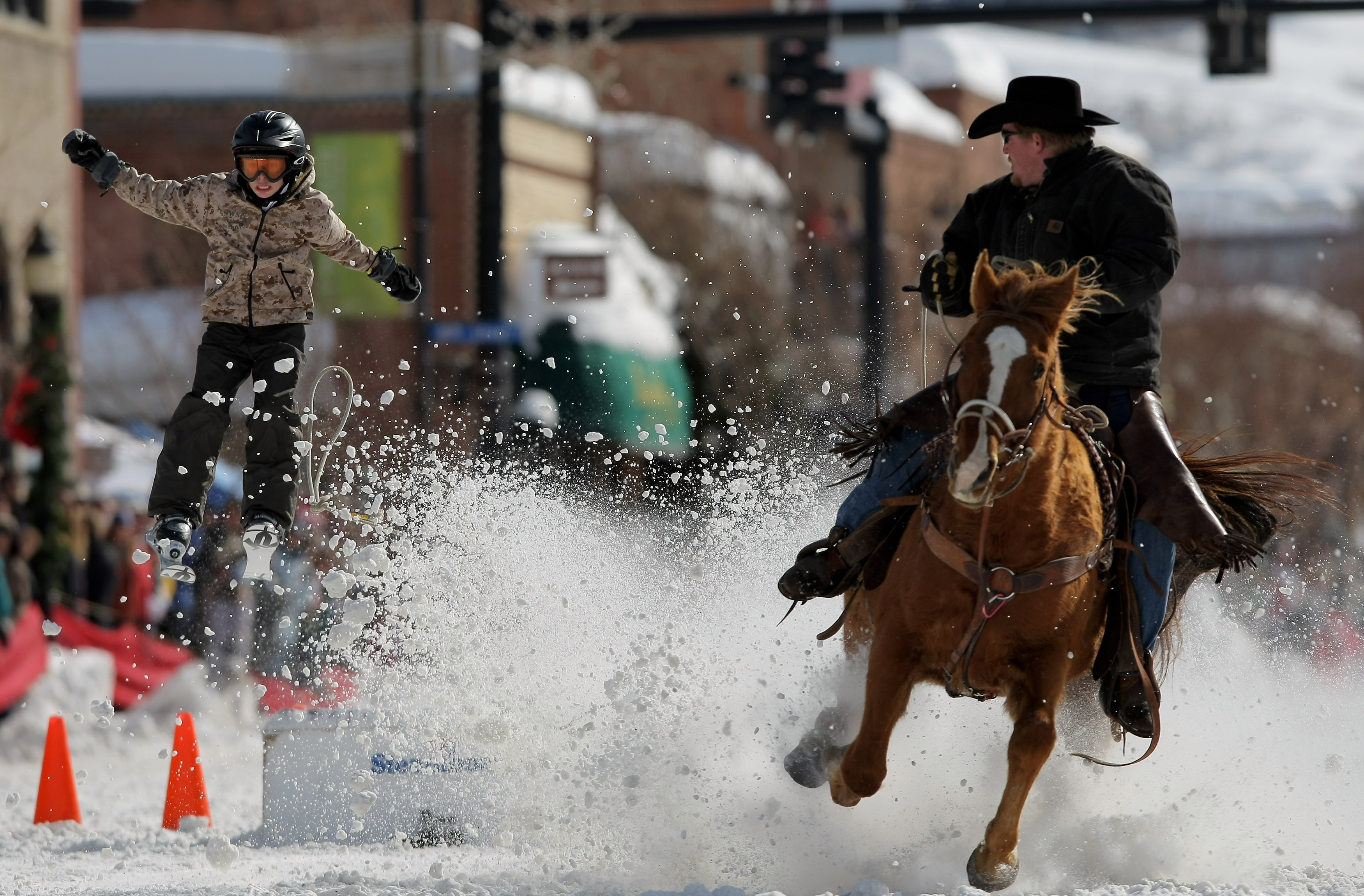 Man riding horse and pulling skier in Steamboat Springs