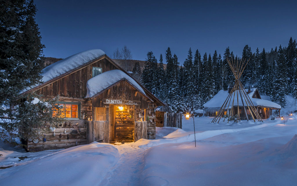 The winter lodges Dunton Hot Springs covered in snow at night