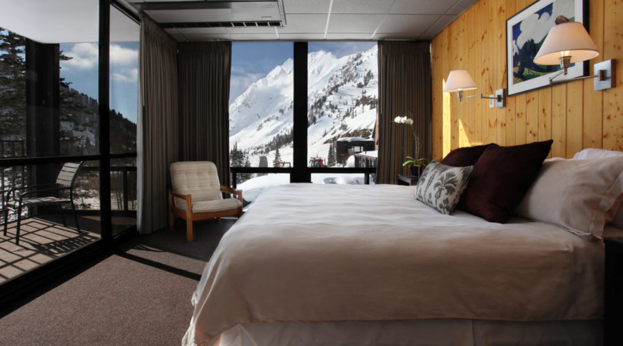 The view of snow-covered mountain from inside a room at Alta Lodge in Utah