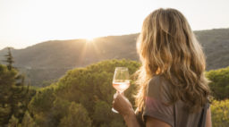 Woman Holding Glass of Rose Wine at Sunset