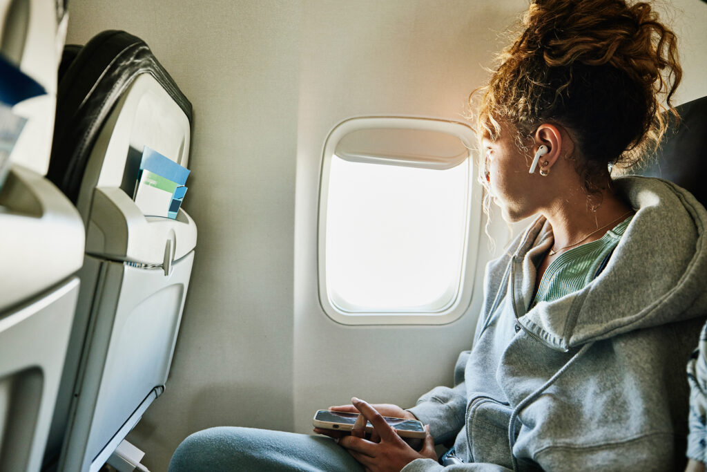Woman Looking Out Airplane Window
