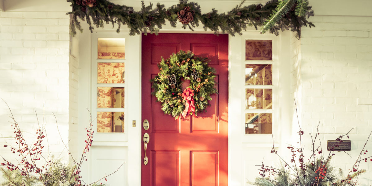 Exterior Red Door Decorated with a Wreath for Christmas