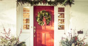 Exterior Red Door Decorated with a Wreath for Christmas