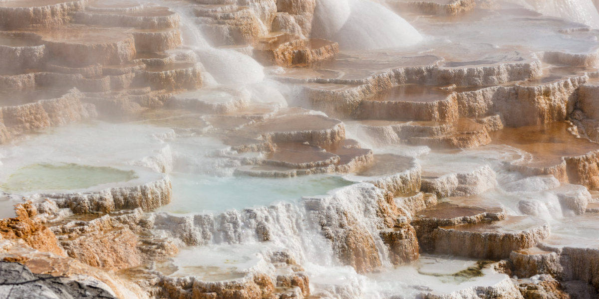 Canary Springs terraces with water rushing down at Mammoth Hot Springs of Yellowstone National Park